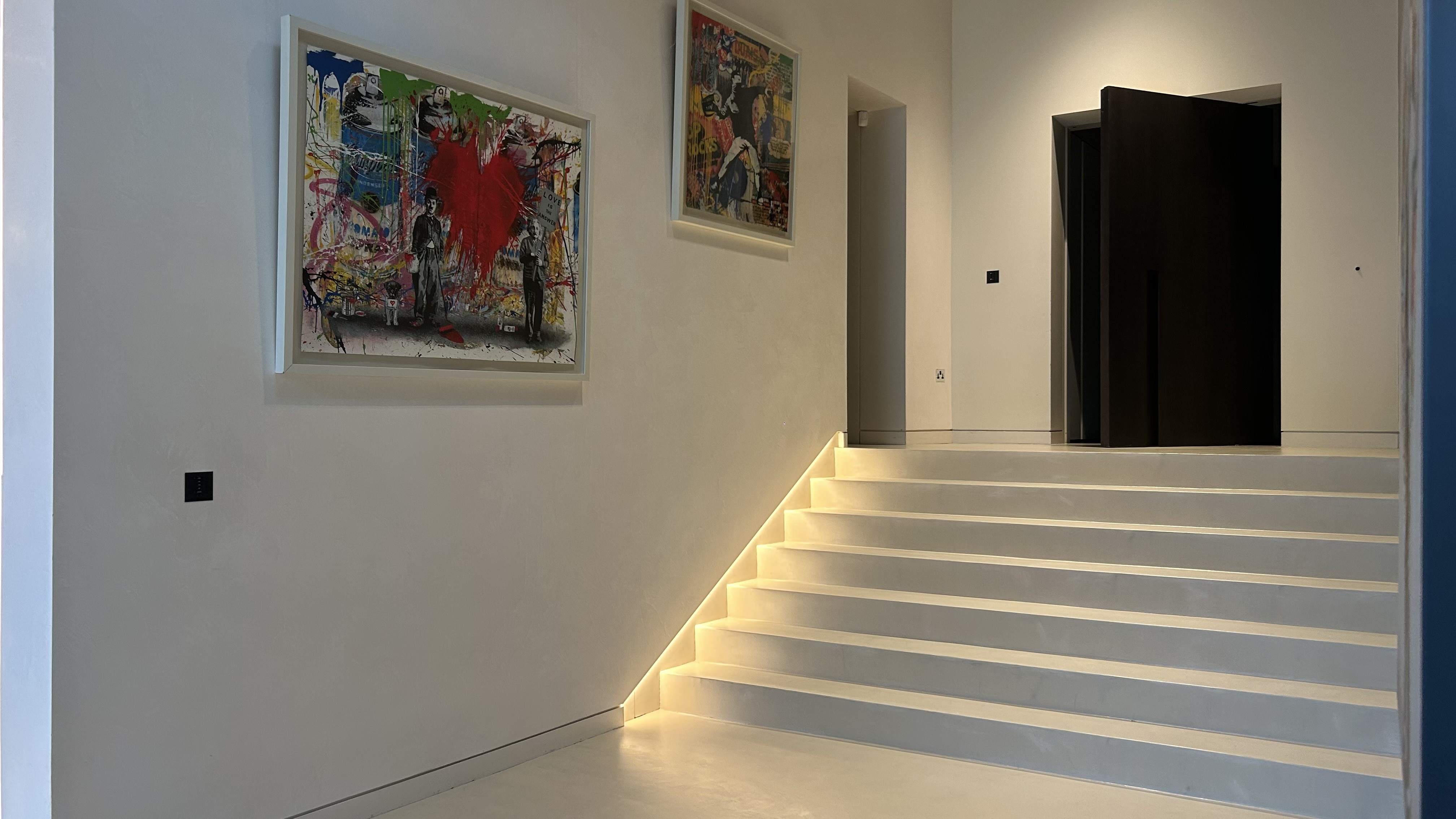 Microcement staircase and hallway with LED lighting in London residence by Atelier di Venice